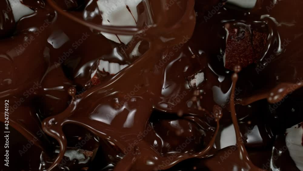 Super Slow Motion Shot of Coconut Pieces Falling into Melted Chocolate at 1000 fps. Super Slow Motion Shot of Coconut Pieces Falling into Melted Chocolate at 1000 fps.