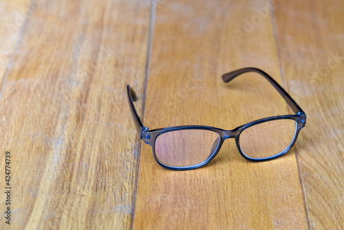 Clear eyeglasses, Glasses transparent grey Frame vintage style on wood background