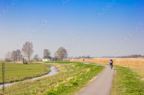Little white house at the bicycle path in the Zaanstreek in The Netherlands