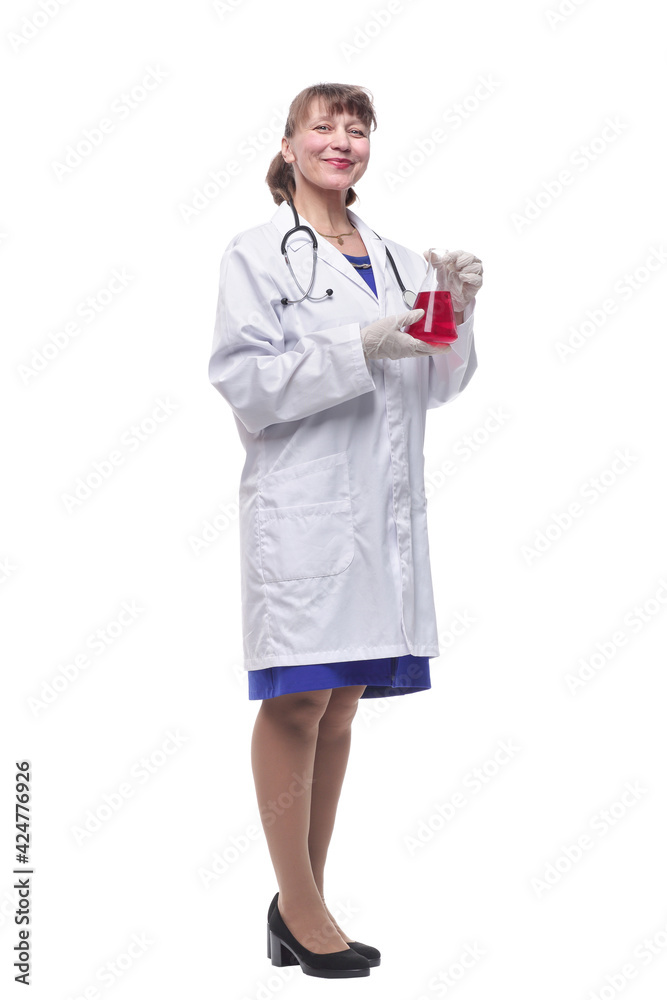 Female scientist looking at beaker of red liquid Female scientist looking at beaker of red liquid