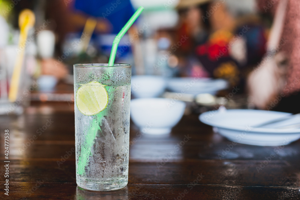 Glass of fresh sparkling water with slice of lime on table. Glass of fresh sparkling water with slice of lime on table.