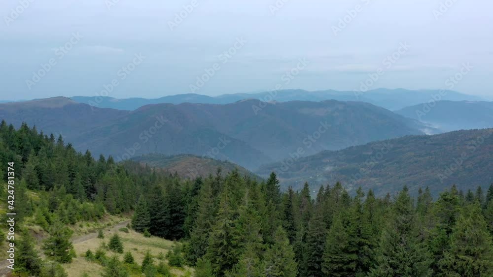 Aerial view of mountain landscape with evergreen pine trees. View from the top of mountain. Aerial view of mountain landscape with evergreen pine trees. View from the top of mountain.
