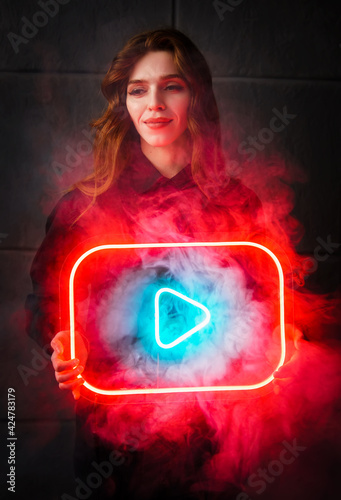 Woman on dark background with play button