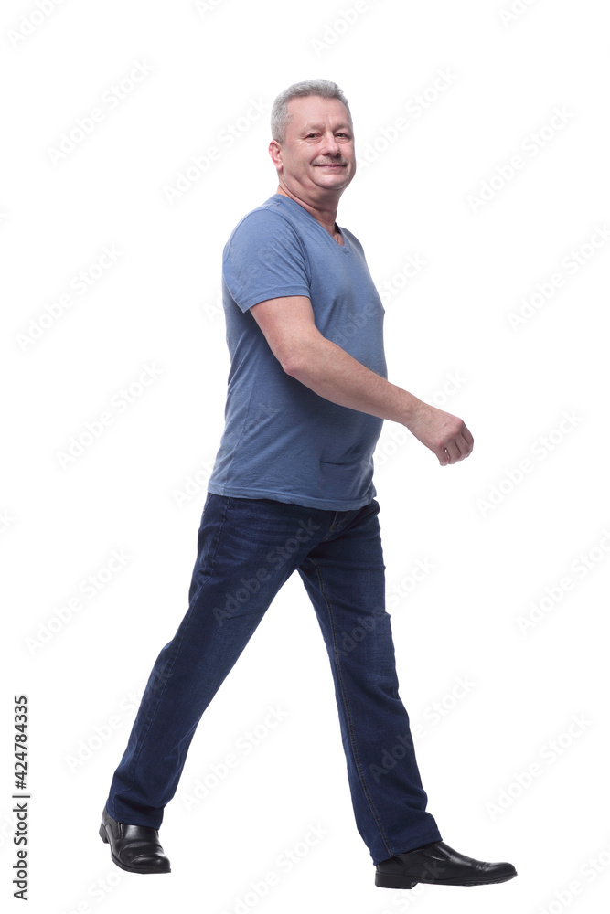 Full length picture of a casual serious man walking towards the camera Full length picture of a casual serious man walking towards the camera