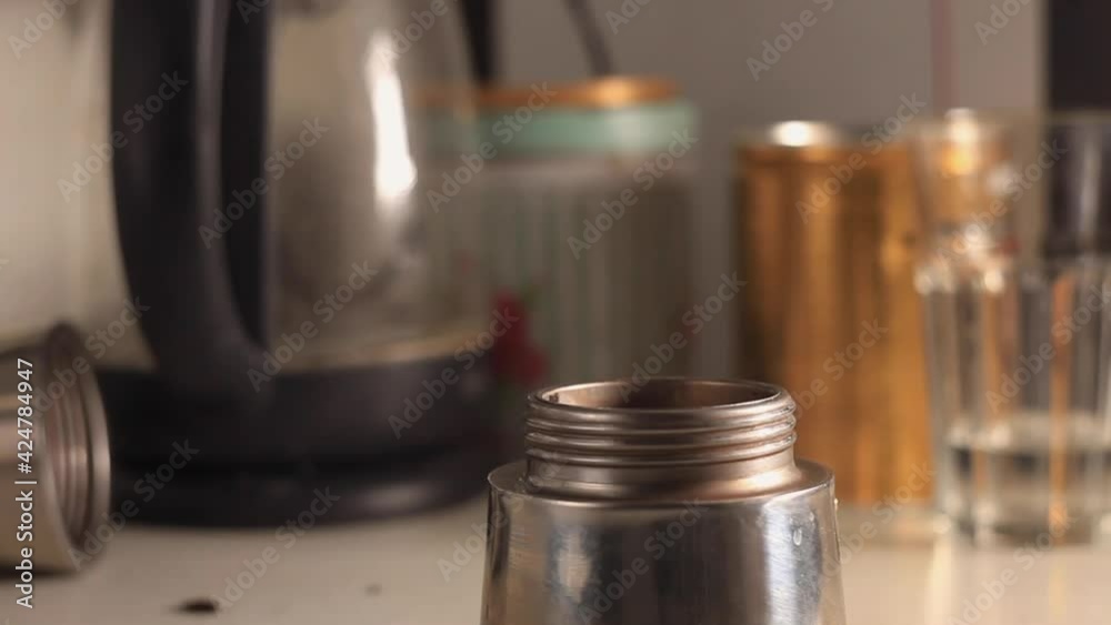 The process of making coffee. Women's hands are taken in close-up. Woman pours water and pours coffee into geyser coffee maker. High quality footage The process of making coffee. Women's hands are taken in close-up. Woman pours water and pours coffee into geyser coffee maker. High quality footage