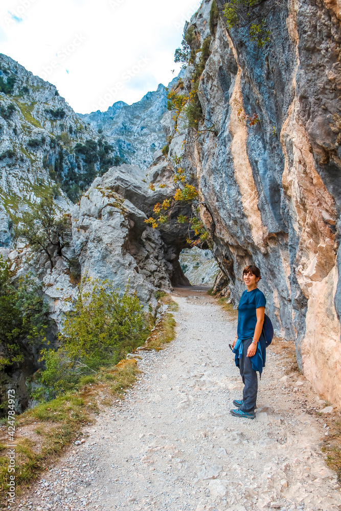 A young woman on the trail in the Picos de Europa, on the Cares route. Asturias