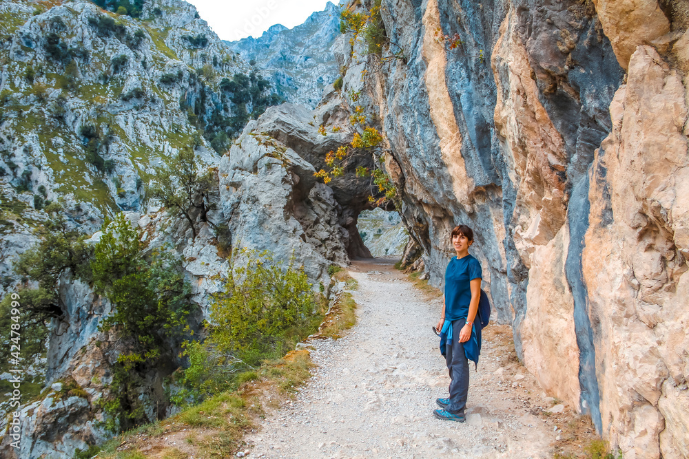 A young woman on the trail in the Picos de Europa, on the Cares route. Asturias