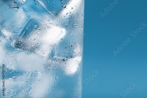Ice cubes in a misted glass with drops of ice water close-up macro. Soft Selective Focus