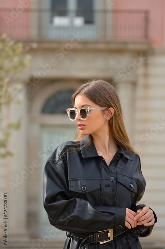 Pretty young sexy fashion sensual woman with tendry sunglasses ,dressed in hipster style ,Stylish fashionable blonde girl hipster in black clothes.