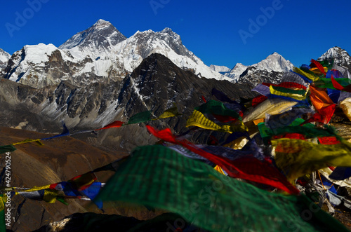 Prayer flags on top of Gokyo Ri (5.360m) and three of the five highest mountains in the world: Mt Everest (8.848m), Lhotse (8.516m) and Makalu (8.462m). Solukhumbu, Sagarmatha National Park, Nepal.