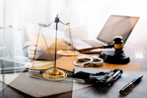 Business and lawyers discussing contract papers with brass scale on desk in office. Law, legal services, advice, justice and law concept picture with film grain effect