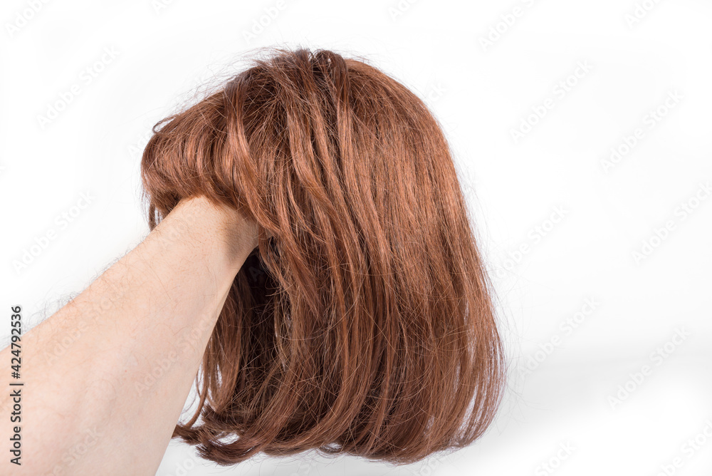 Short red hair wig on a white background Short red hair wig on a white background