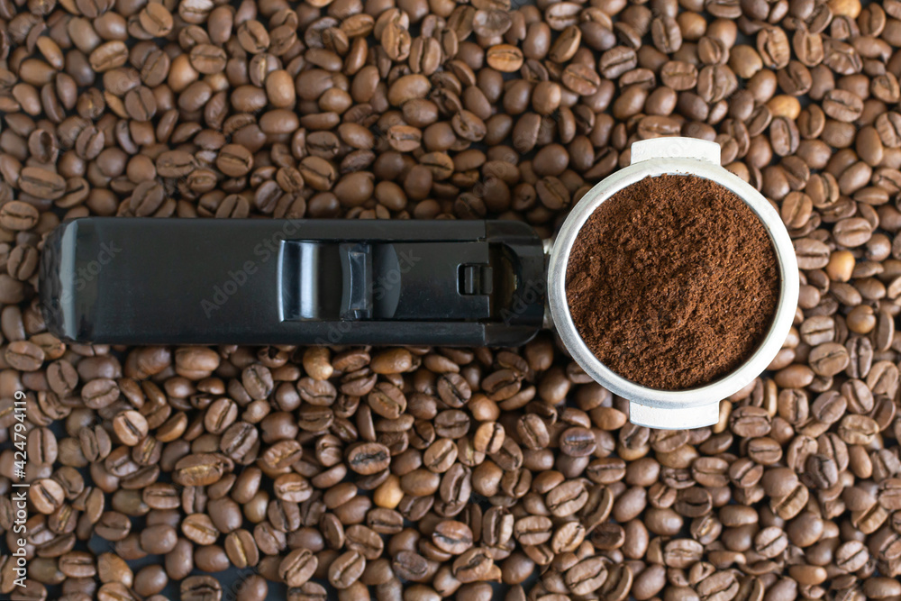 Fototapeta premium Ground coffee in a horn among the beans. Home coffee making concept. Horizontal orientation. Top view.