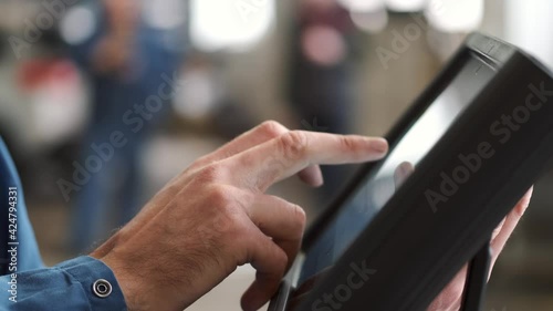 Mechanic uses a tablet at the car service