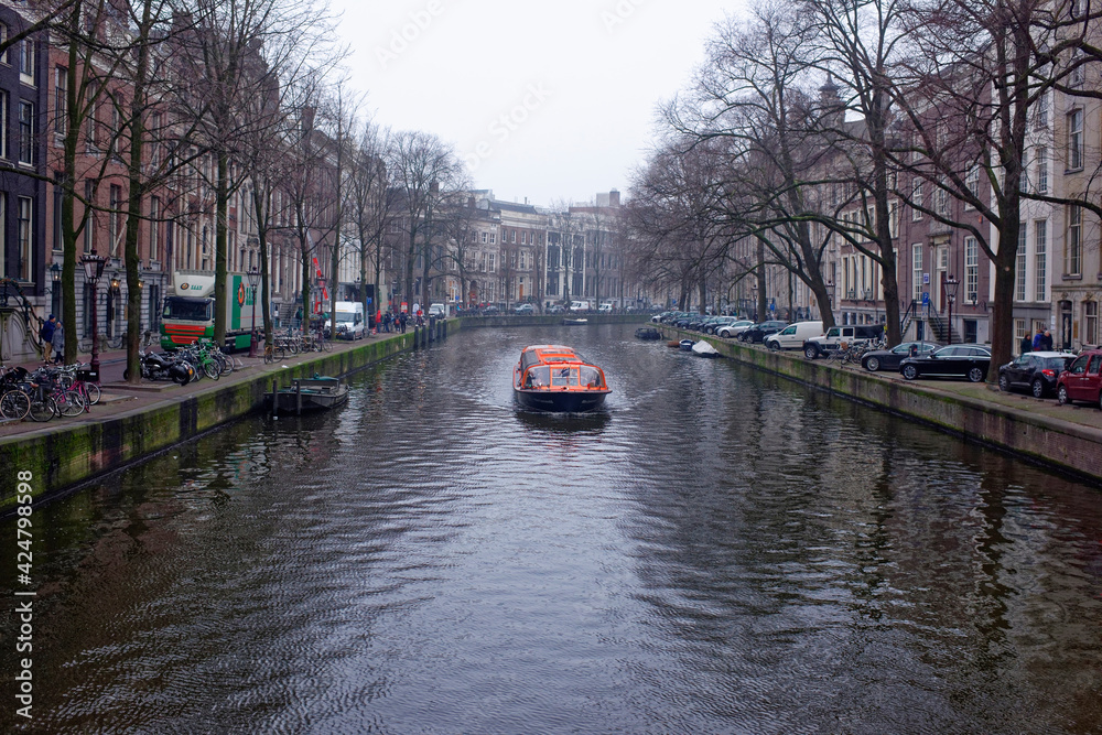   Along the canal walk citizens and moving vehicles