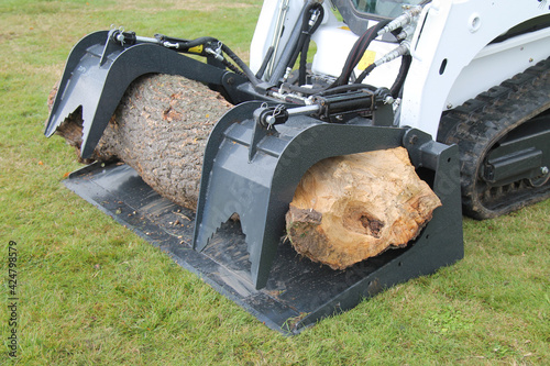 Canvas Print A Farming Grapple Bucket Moving a Large Tree Trunk.