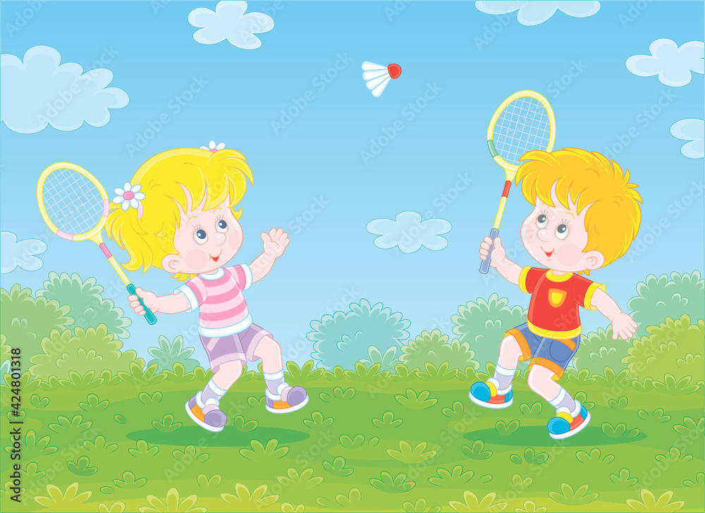 Happy little kids playing badminton with rackets and a flying shuttlecock in a fun game on a green playground in a summer park, vector cartoon illustration