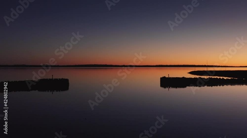 Drone Over Tranquil Waters At Sunset photo