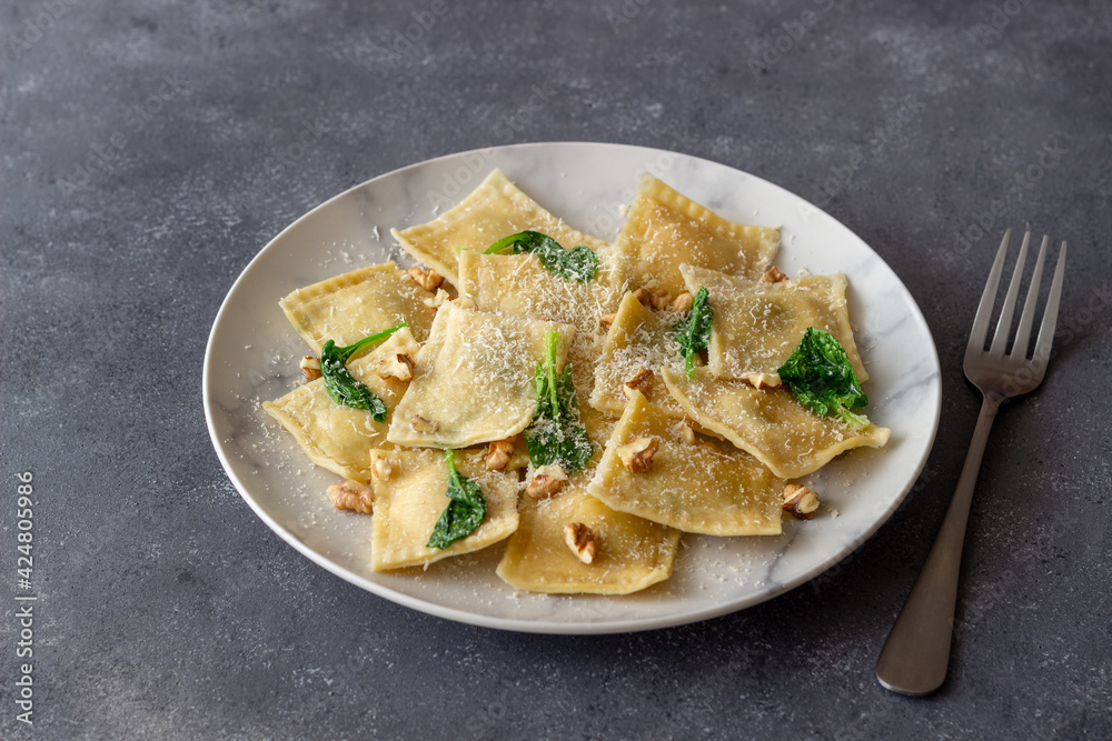 Ravioli with ricotta cheese, spinach and nuts. Healthy eating. Vegetarian food. Italian cuisine. Ravioli with ricotta cheese, spinach and nuts. Healthy eating. Vegetarian food. Italian cuisine.