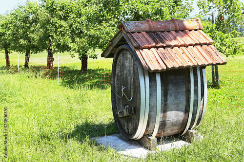 Old barrel for cider in the Alpine village standing outdoors