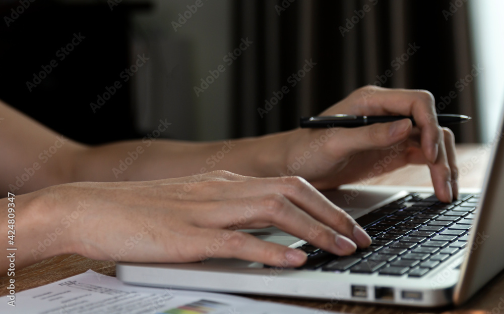 Male hand using laptop computer working on wooden table at home. Using laptop for searching web browsing, and having working workplace at home. Working from home office, hand on keyboard close up. Male hand using laptop computer working on wooden table at home. Using laptop for searching web browsing, and having working workplace at home. Working from home office, hand on keyboard close up.