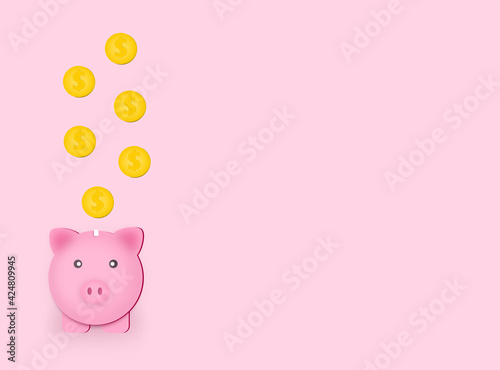 Golden coin dropping in pink piggy bank for save money concept on pink background.