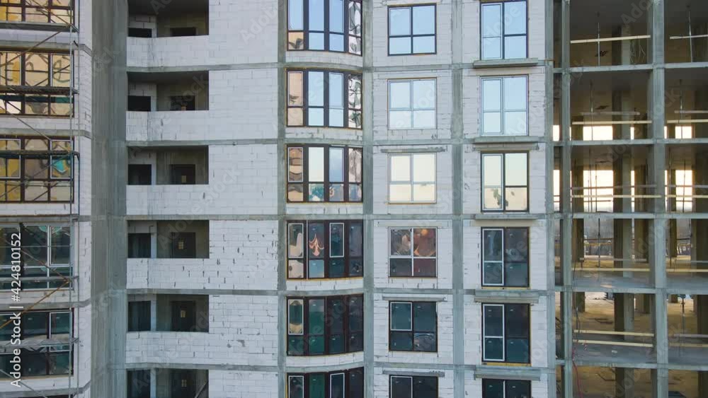 Aerial view of high residential apartment building under construction. Real estate development.