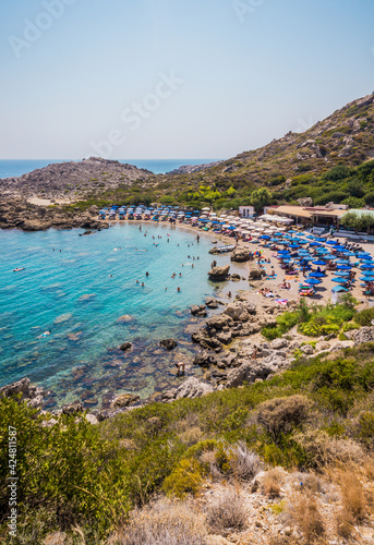 Beautiful Ladiko bay Beach with clear blue water near Faliraki, Rhodes island, Greece on a sunny summer day.