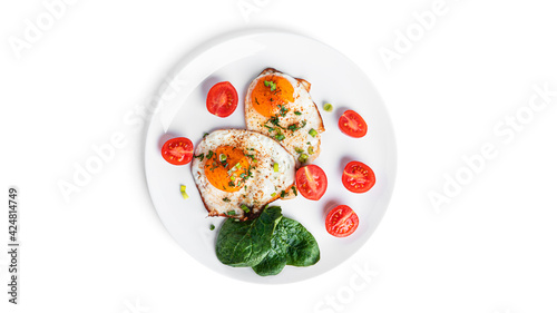 Fried eggs with vegetables on white plate isolated on a white background. Beautiful breakfast.