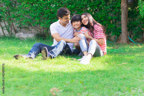 Happy lovely beautiful Asian family father, mother, and son in the backyard