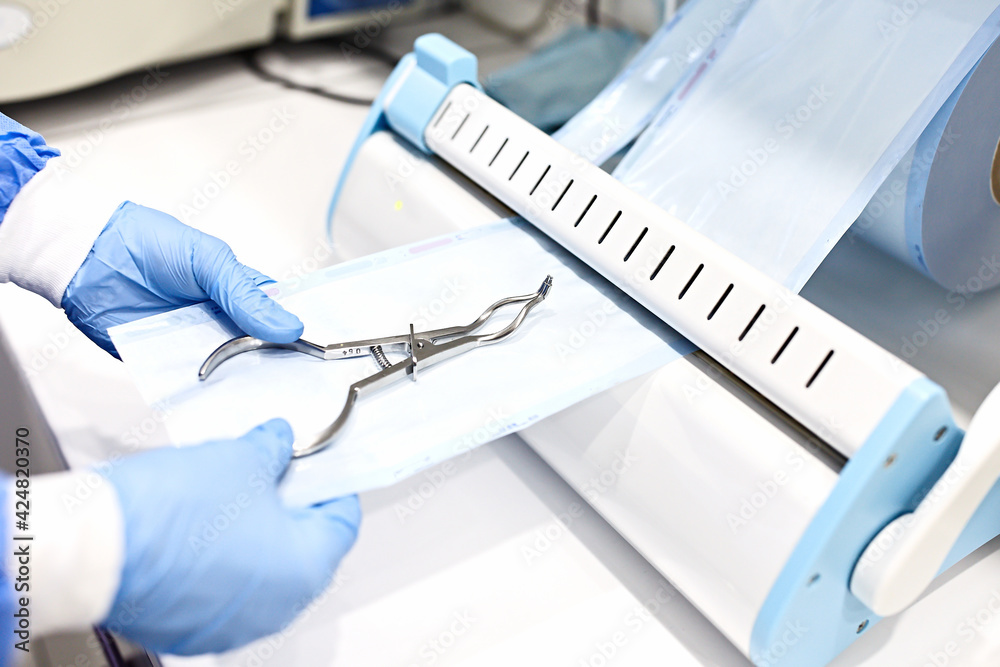 Sterilizing medical instruments in autoclave. Dental office. Close up