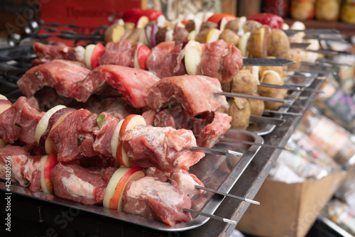 Raw meats and vegetables are skewered before being cooked at a street food cafe.