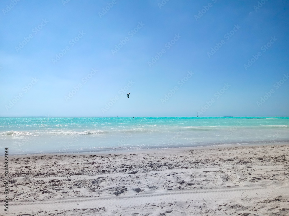 Kite surfing on the White Beach Rosignano Solvay with Caribbean-blue waters and bright white sands on sunny day. Tuscany, Italy Europe
