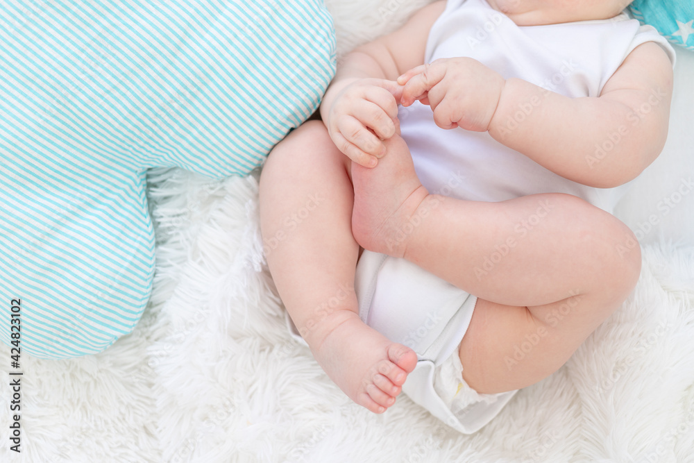 baby legs with handles on the bed in the blue and white bed baby legs with handles on the bed in the blue and white bed