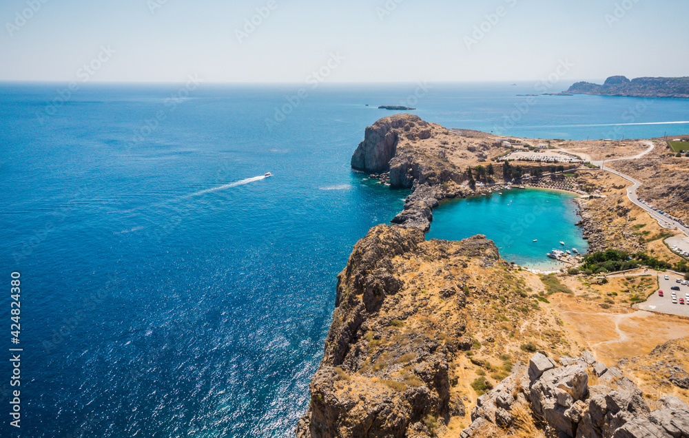 Beautiful heart shaped Saint Paul's Bay with blue azure water view from Acropolis of Lindos, Rhodes, Greece