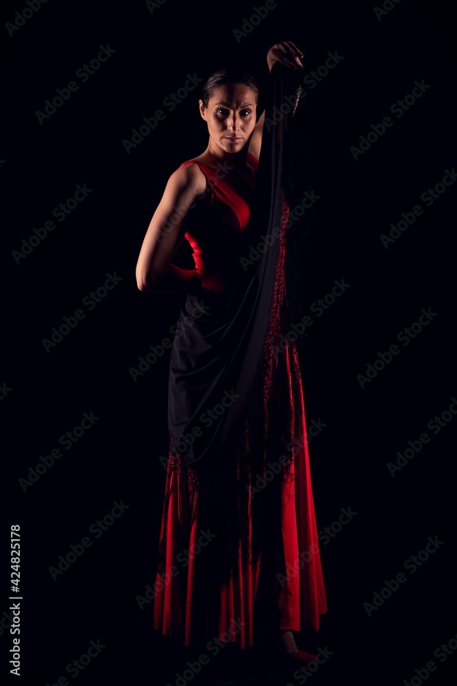 flamenco woman in red skirt and lifting black shawl