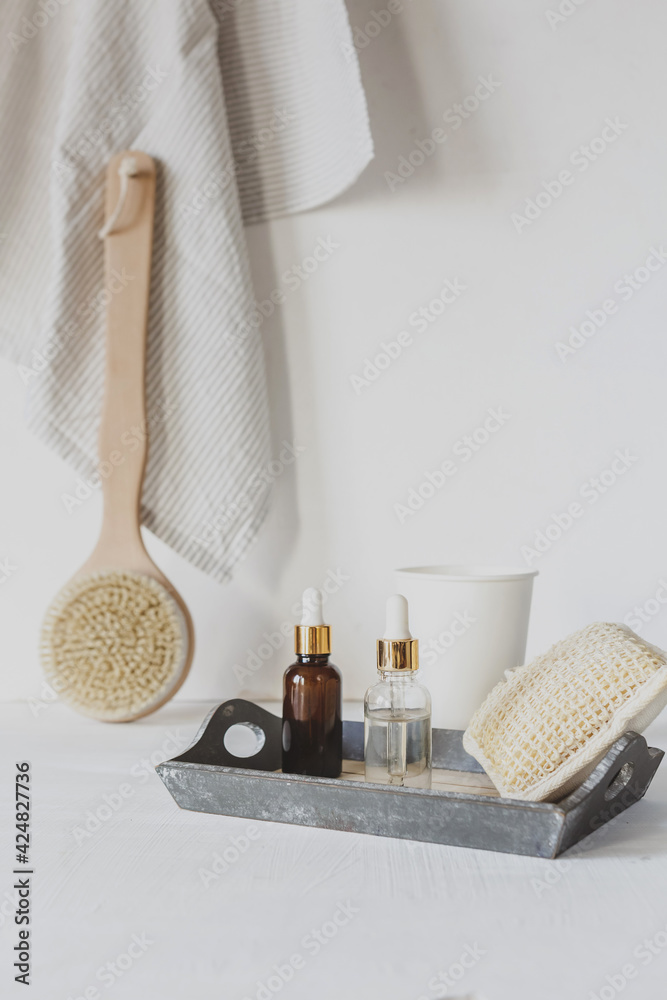 Zero waste, sustainable bathroom and lifestyle. Bamboo massage brush, loofah sponge, natural oil, DIY products in glass bottles on white background.Eco cosmetics