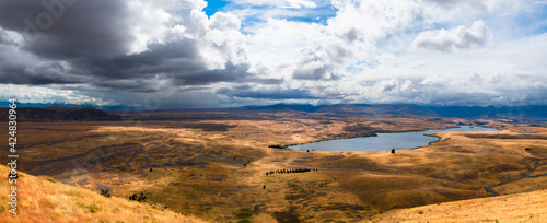 New Zealand dry meadow in autumn with dramatic sky