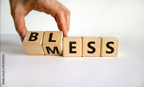 Bless mess symbol. Businessman turns the cube and changes the word 'mess' to 'bless'. Beautiful white table, white background, copy space. Business and bless mess concept.