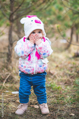 Portrait of little toddler girl having fun outdoors in cold weather at mountains