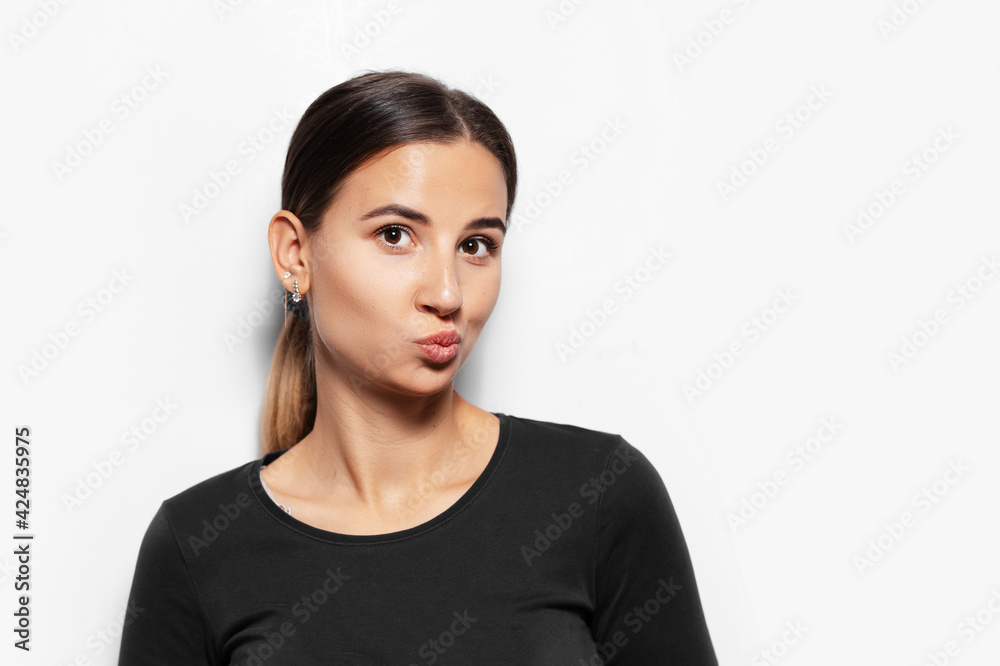 Studio portrait of young brunette girl send air kiss on white background. Studio portrait of young brunette girl send air kiss on white background.