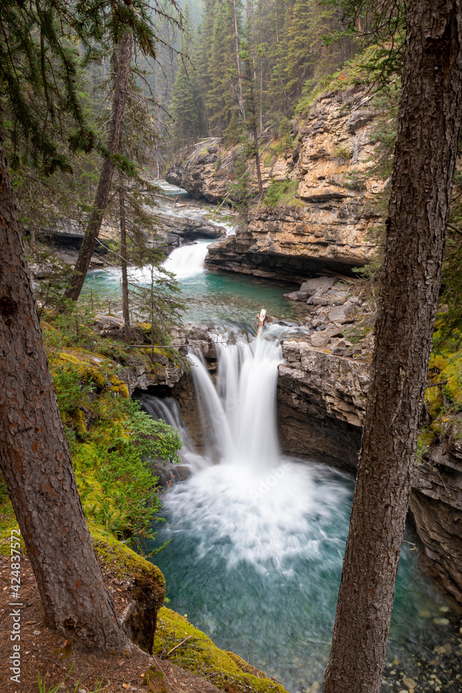 Fototapeta premium Long exposure shot of a waterfall in a canyon