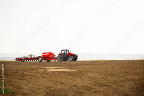 Large modern tractor for preparing the field after winter for sowing grain. Agricultural machinery