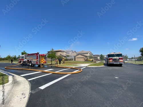 fire trucks putting out a fire in home in orlando florida lake nona 
