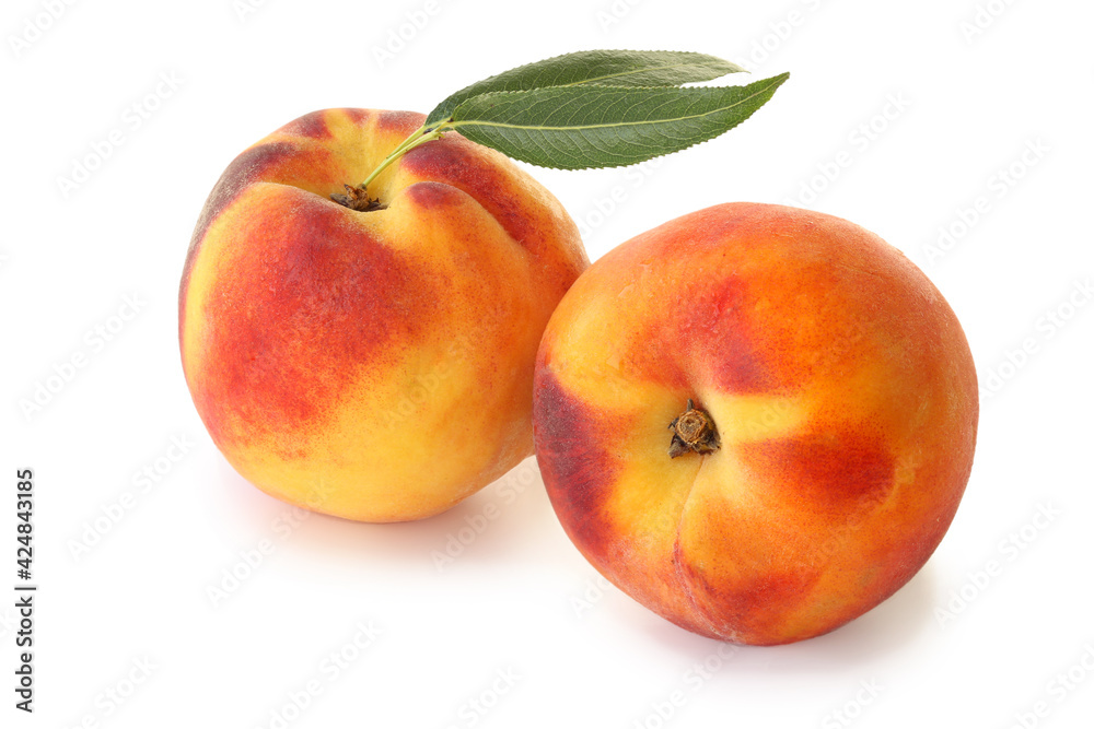 Two peaches with leaves isolated on white background Two peaches with leaves isolated on white background