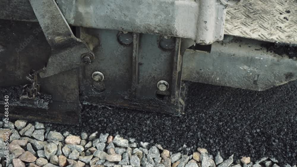 Asphalt paver. Construction of a new road. Special equipment makes a road in a small town, village. A team of workers makes road surface repair, reconstruction
Asphalt paver. Construction of a new road. Special equipment makes a road in a small town, village. A team of workers makes road surface repair, reconstruction