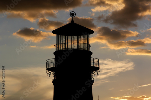 Silhouette of old lighthouse on a sunset almost nightfall