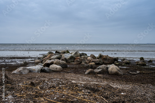 Boulders at Lomma Beach, Malmo, southern Sweden. Blue sky and ocean in the background