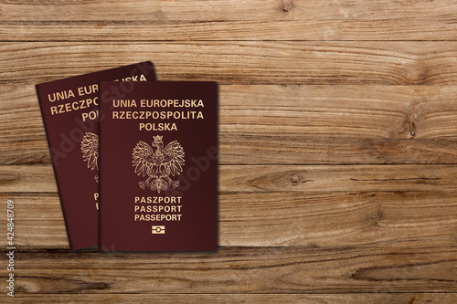Polish passports on a wooden background, Polish nationality