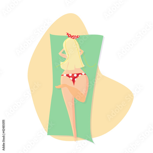 body positive blonde girl in a red polka dot swimsuit in pin up style sunbathing on the beach